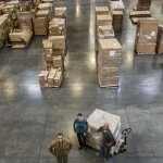 a-group-of-three-warehouse-workers-standing-in-the-2025-04-03-00-35-38-utc